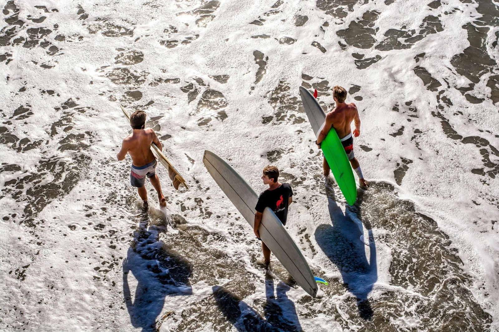 A group of surfers are going to the ocean